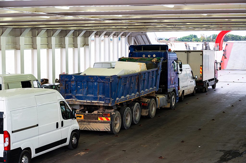 Several vehicles including cars and trucks lined up.