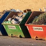 Several skip bins filled with assorted materials