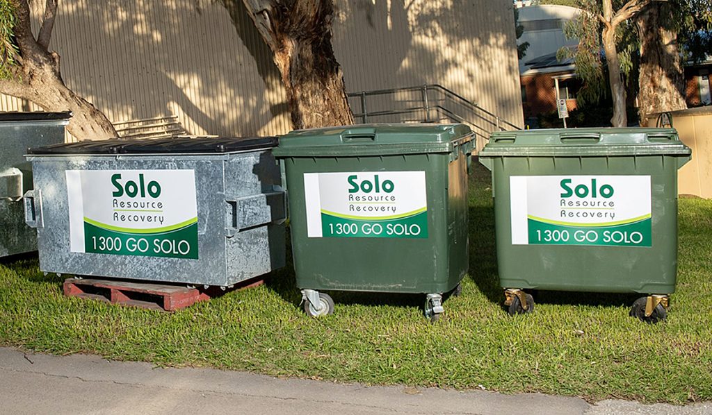 Three industrial bins situated outside