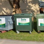 Three industrial bins situated outside