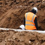 Two workers amongst soil on a building site