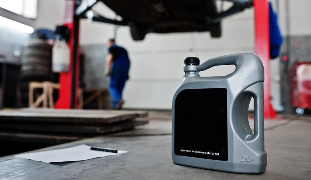 A bottle of oil in a car workshop