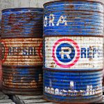 Two aged metal barrels