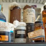 A collection of used hazardous waste bottles