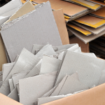 A pile of used cardboard stacked together