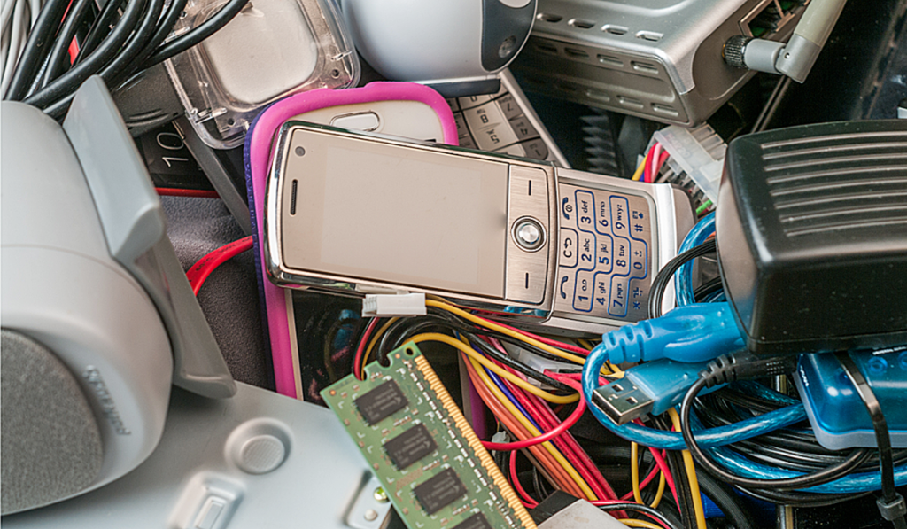 Electronic devices ready for e-waste recycling in Adelaide, including mobile phones, cables and computer components