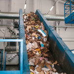 Recycling in Adelaide at a resource recovery facility sorting recyclable materials on a conveyor belt
