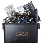 E-waste including computers, keyboards and cables in a recycling container