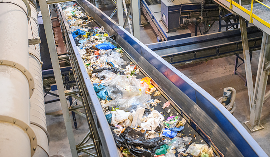 Waste being sorted on a conveyor at a recycling centre