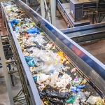 Waste being sorted on a conveyor at a recycling centre